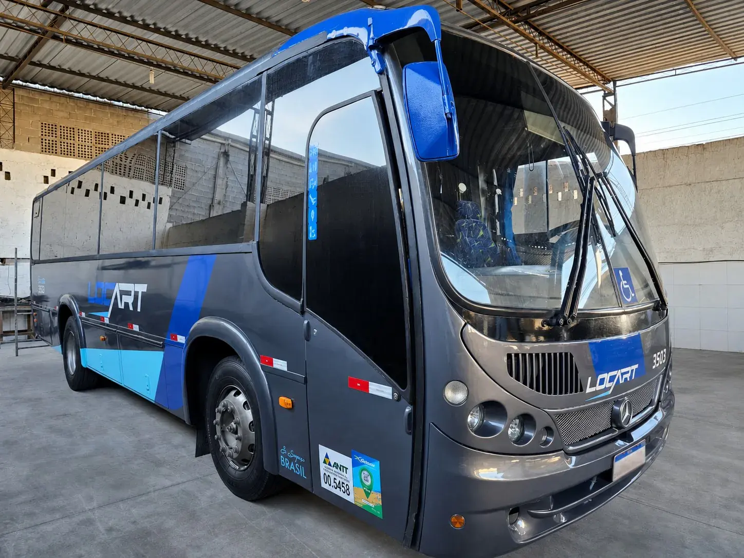 Ônibus executivo Locart 3503 visto em ângulo frontal no pátio coberto